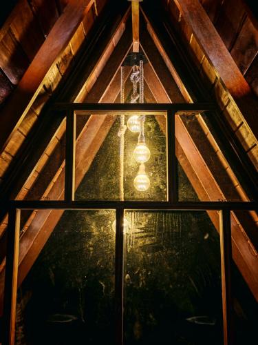 a chandelier hanging from the ceiling of a attic at Paddy field Whispering wind Cabin in Ahangama Nakanda