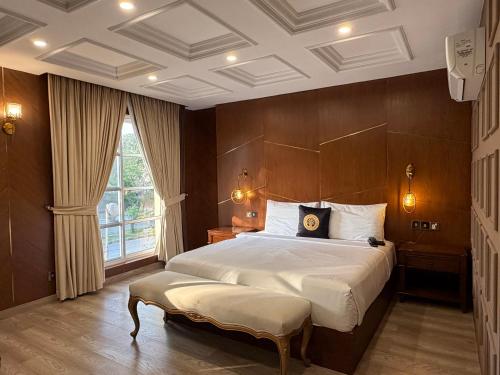 a bedroom with a large bed and a large window at THREE TREE Signature Hotel-G7 Markaz Islamabad in Islamabad