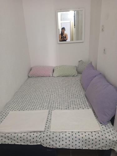 a small bed in a room with a mirror at Mina in Krašići