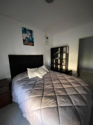 a bedroom with a large bed in a room at El Quincho in Lobos