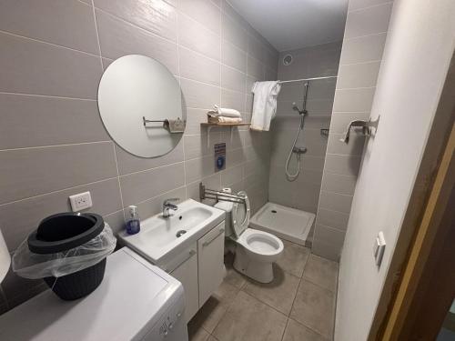 a bathroom with a sink and a toilet and a mirror at Studio tout équipé à la nuitée ou plus,proche aéroport Bastia in Lucciana