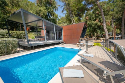 a house with a swimming pool and a house at Porton Nature Hideouts in Rovinj