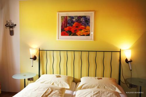a bedroom with two beds and a painting on the wall at Land-Gast-Hof WALKMÜHLE in Feuchtwangen