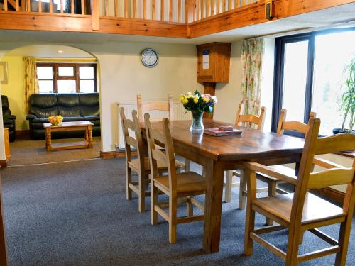 a dining room with a wooden table and chairs at Fennel in Kelly