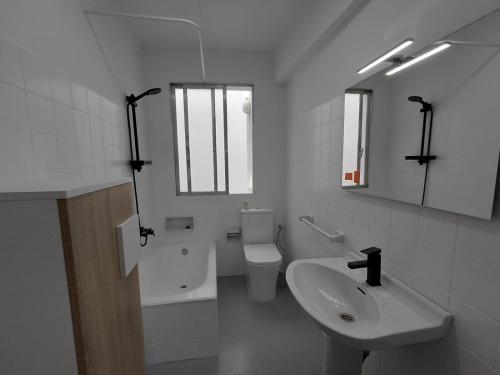 a white bathroom with a sink and a toilet at Pedra Pateira 2 in Ribeira