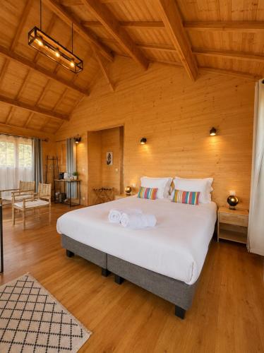 a bedroom with a large white bed in a room at Le Domaine de La Tour des Vents in Bergerac