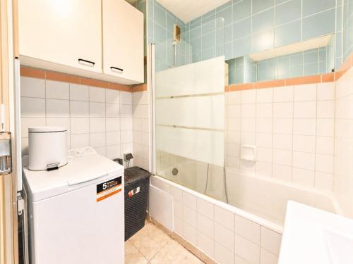 a small kitchen with a refrigerator and a shower at Urban Nest Geneva Tramway in Gaillard