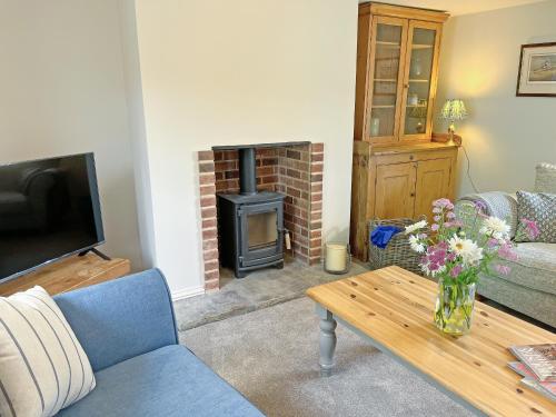 a living room with a couch and a fireplace at The Dairy - Uk50427 in Malton