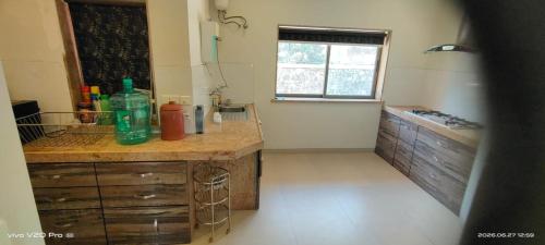a kitchen with a counter with a sink and a window at Holiday villa in Lonavala