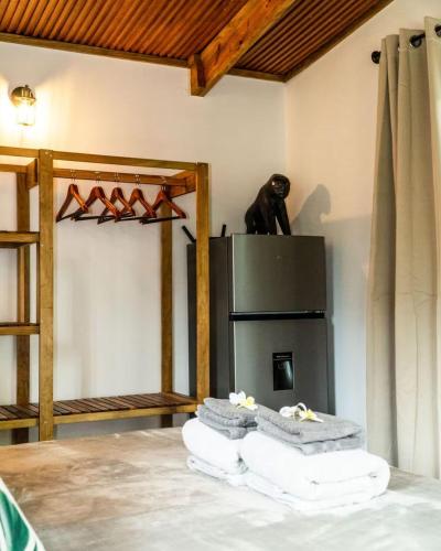 a room with a bear on top of a refrigerator at Bocas Stoked Monkeys in Bocas Town
