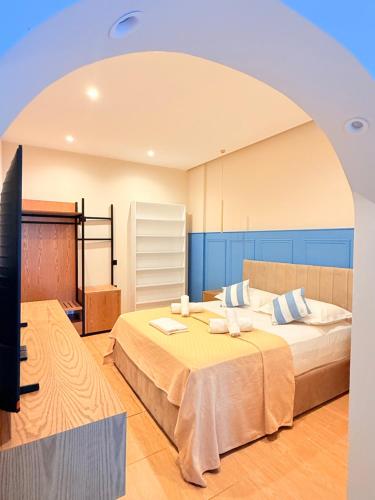 a room with two beds and a flat screen tv at Rida Village Hotel Ksamil Island in Ksamil