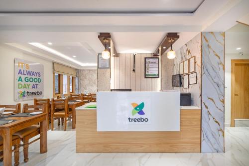 a restaurant with tables and a sign that says it always a good day at taco at Treebo Sheel, Near Mall Road in Shimla