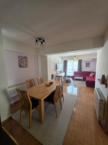 a living room with a wooden table and chairs at Apartment Love in Vlasic