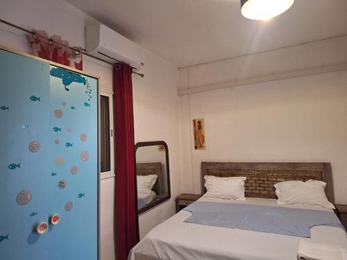 a small bedroom with a bed and a window at Location chambres chez Zam in Mamoudzou