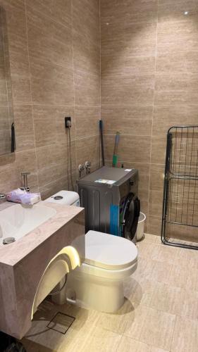 a bathroom with a toilet and a sink at Spacious Two-Bedroom Apartment with a Large Living Room, comfortable and well organized, perfect for a relaxing stay in Jeddah