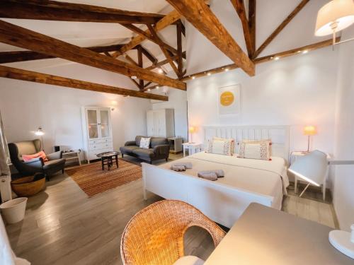 a bedroom with a bed and a living room at Attalos Suites Hotel in Bergama