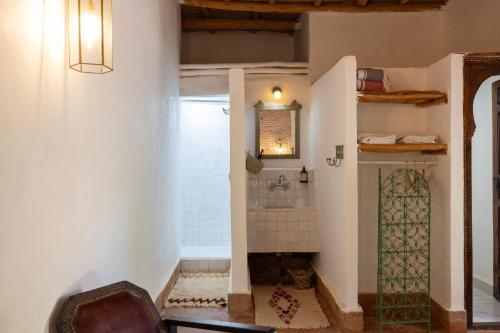 a bathroom with a shower in the corner of a room at Sel d Ailleurs, Ouirgan - adults only in Ouirgane