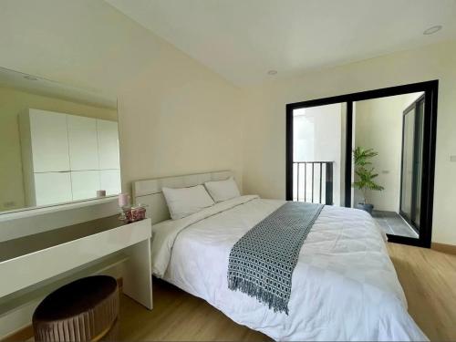 a bedroom with a large bed and a large window at condoTip in Loei