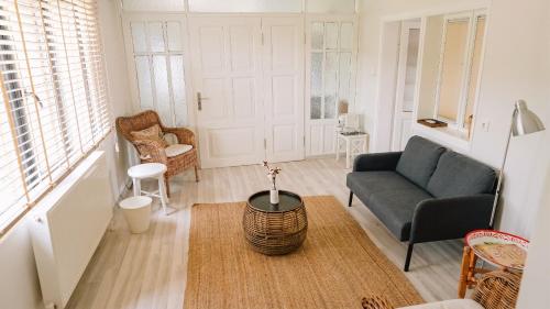 a living room with a couch and a table at Attalos Suites Hotel in Bergama