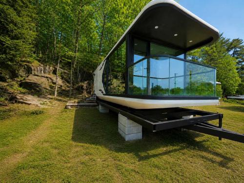 a house with a window sitting on top of a field at #41 Space Capsule 1-bdr in Parry Sound