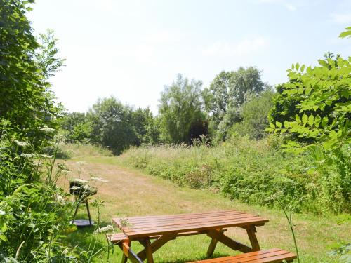 a wooden picnic table in a field with a trail at Great Meadow in Kelly