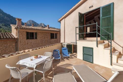 a patio with a table and chairs on a building at Can Mayol in Fornalutx