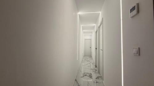 a hallway with white walls and a long corridor at Victory in Alicante