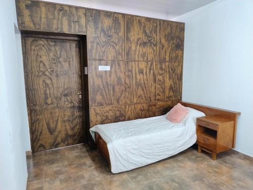 a bedroom with a bed and a wooden wall at Haus Eldorado in Eldorado