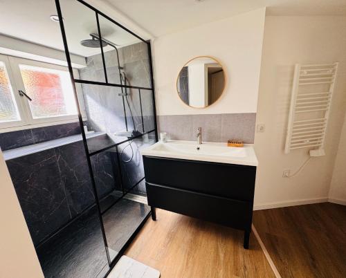a bathroom with a sink and a shower at Le Manana in Crozon