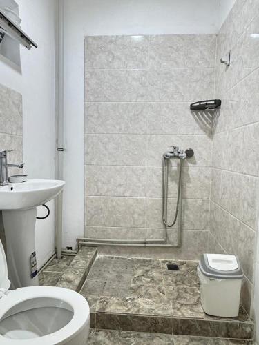 a bathroom with a shower and a toilet and a sink at AI-NUR guest house in Shabdan