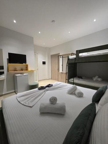 a bedroom with a bed with towels on it at Vila Sokrati in Mursi