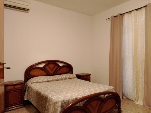 a bedroom with a bed and a window at Casa Anna in Ladispoli