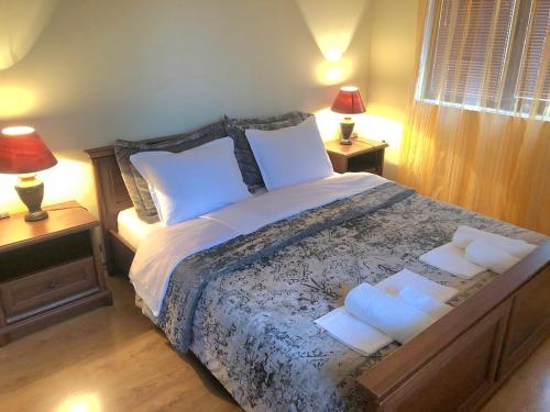 a bedroom with a large bed with two night stands at Apartment Villa al Mare 1 in Shkorpilovtsi