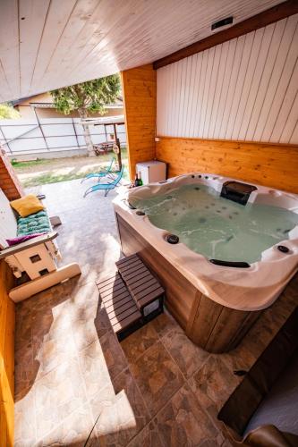 a large jacuzzi tub in a building at Gyarmati Vendégház Sirok in Sirok