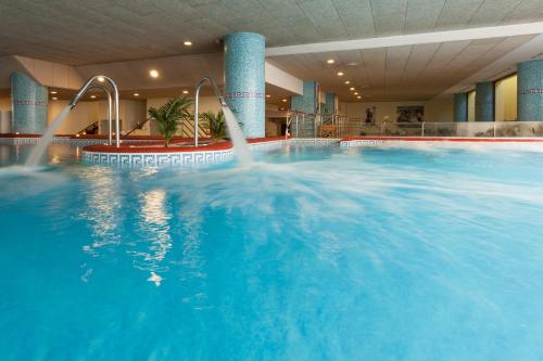a large blue swimming pool in a building at Senator Marbella in Marbella