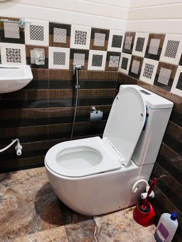 a bathroom with a white toilet and a sink at Harsha Villa Dickwella in Dickwella