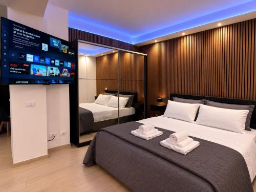 a bedroom with a large bed with two towels on it at Seven Suite SPA in Fiumicino