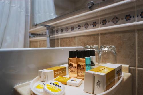 a bathroom counter with boxes ofodorizers and a bath tub at Omar Khayyam Hotel in Bukhara