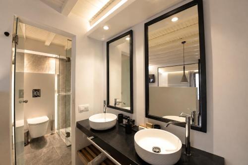 a bathroom with two sinks and a shower at Mykonos View Hotel in Mikonos