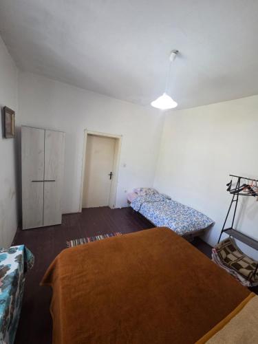 an empty room with two beds and a table at Maki 4 in Radanovići