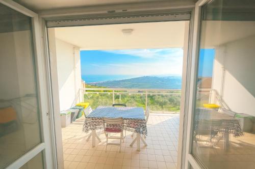 a glass door leading to a patio with a table and chairs at DreamLiving Vasto Panorama in Vasto