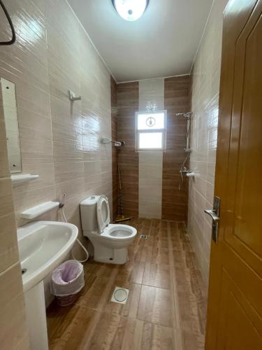 a bathroom with a toilet and a sink at Adheeiz beach in Salalah