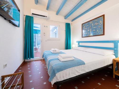 a bedroom with a blue and white bed with blue curtains at Sweet home Santa Lucia in Santa Lucia