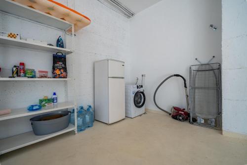 a kitchen with a refrigerator and a washing machine at Villa Panoramic in Santa Susanna