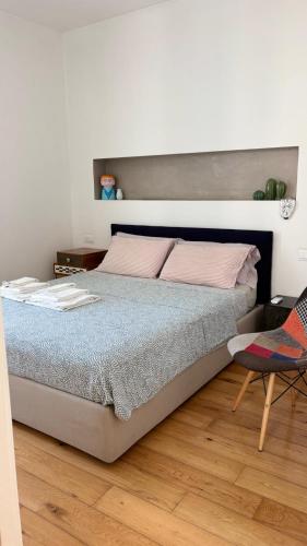 a bedroom with a bed and a chair at Bella Vista Città Vecchia in Polignano a Mare