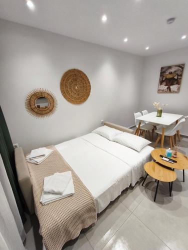 a bedroom with a bed and a table and a tableablish at Minimal Apartments Parga in Parga