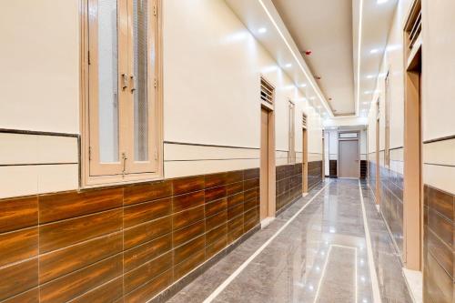 a hallway of a hospital with wooden floors and windows at Hotel O BAL GOPAL in Delhi
