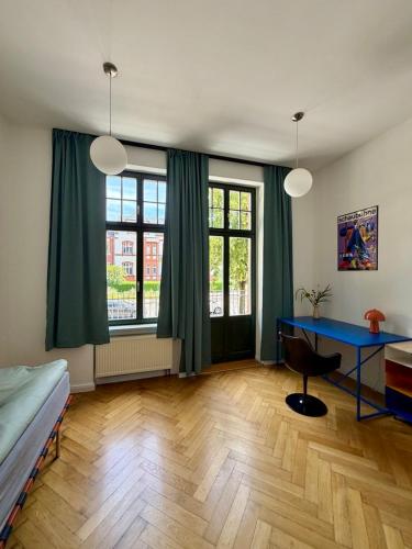 a bedroom with a blue desk and a bed at Bauhaus Suite Dessau in Dessau