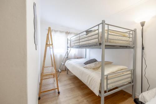 a bedroom with a bunk bed and a ladder at Casa da Floresta in Machico