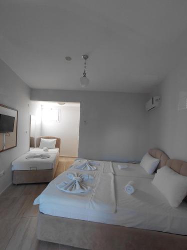 a bedroom with a large bed and a couch at Begonvil Otel in Emin Sitesi